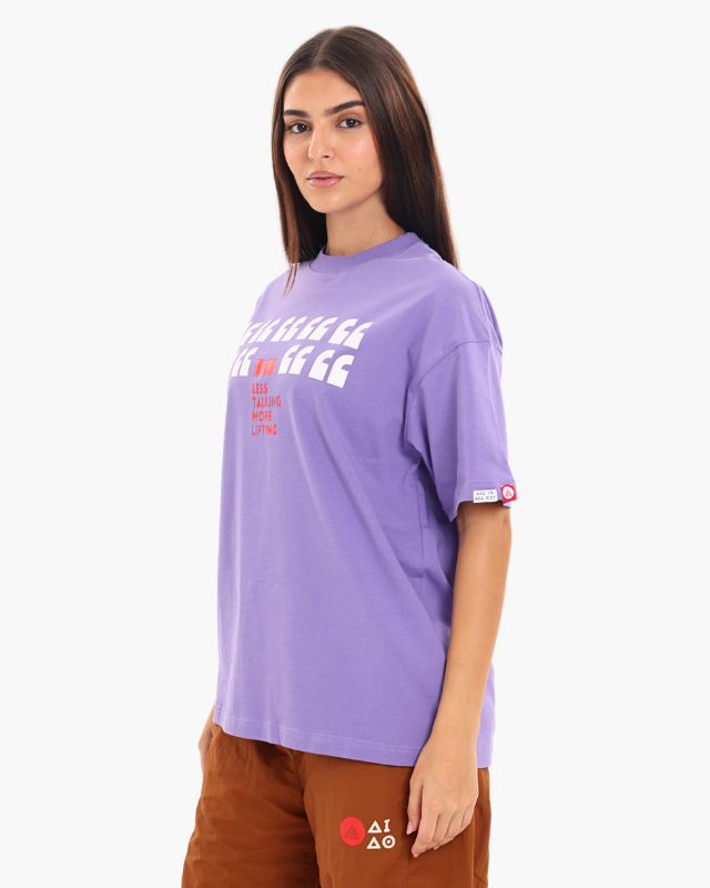 Woman wearing a purple oversized unisex t-shirt side pose