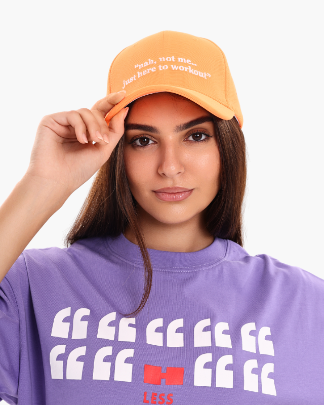 Woman wearing a purple oversized unisex t-shirt with cap