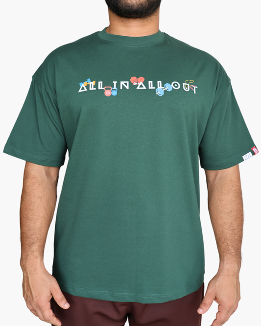 Green t-shirt with 'All In All Out' text and colorful graphics worn by a person